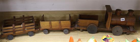 An early 20th century scratch built teak toy locomotive and two wagons overall 123cm